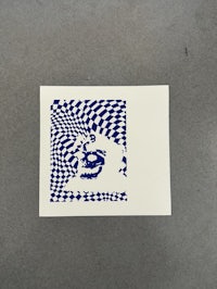 a blue and white sticker with a checkered pattern